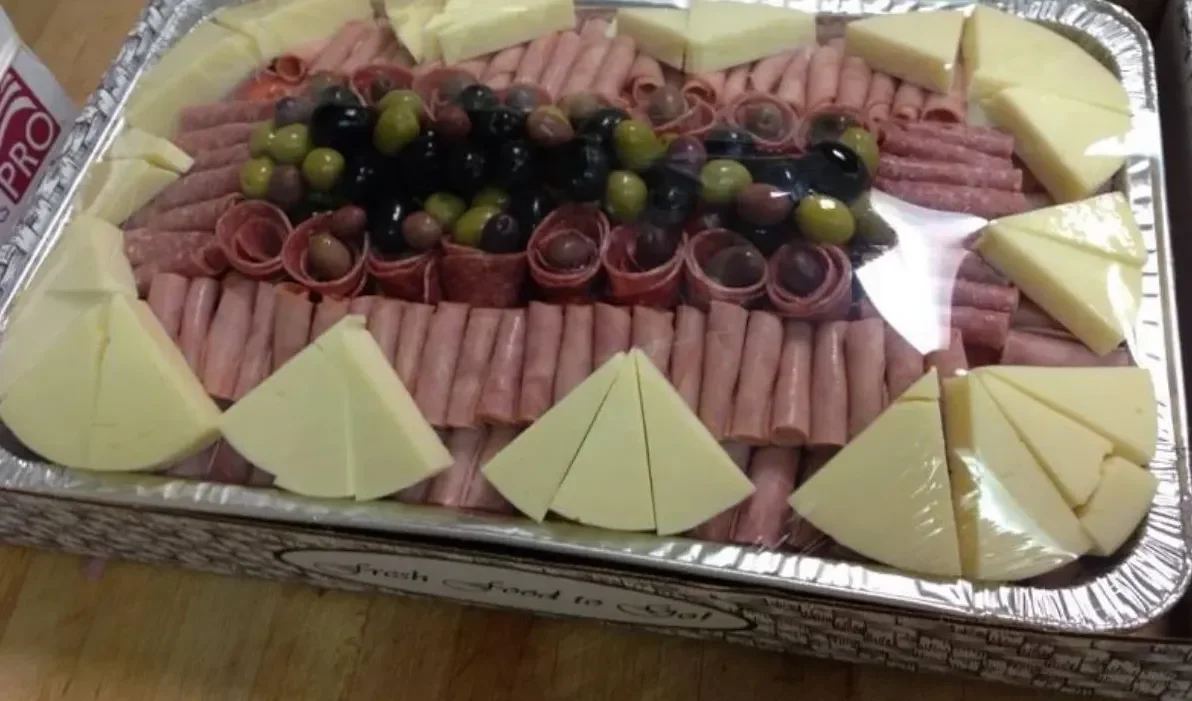 A party platter with cold cuts, cheese and olives