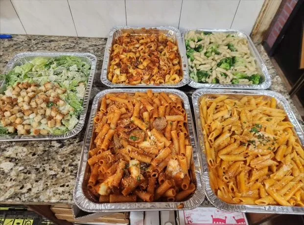 A gathering-sized spread of Mario’s pasta trays and salads